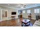 Spacious living room featuring hardwood floors, recessed lighting, and a wet bar at 2307 Carriage Oaks Dr, Raleigh, NC 27614