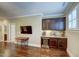 The living room has a wet bar with a wine cooler, hardwood floors, and natural light at 2307 Carriage Oaks Dr, Raleigh, NC 27614