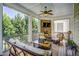 Screened porch with stone fireplace, ceiling fan, and comfortable seating area at 2307 Carriage Oaks Dr, Raleigh, NC 27614