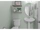 Cozy powder room with pedestal sink and shelves at 2412 Castleburg Dr, Apex, NC 27523