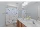 Bathroom with a double sink vanity and a floral shower curtain at 2412 Castleburg Dr, Apex, NC 27523