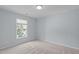 This bedroom features carpet, a neutral paint color, and a single window at 2412 Castleburg Dr, Apex, NC 27523