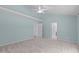 This bedroom features carpet, a ceiling fan, and many doors at 2412 Castleburg Dr, Apex, NC 27523