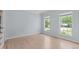 Empty bedroom showcasing hardwood floors, neutral paint, and natural light from the double windows at 2412 Castleburg Dr, Apex, NC 27523