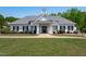 A clubhouse with Greek Revival style columns, black shutters and a gray shingle roof at 2412 Castleburg Dr, Apex, NC 27523