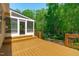 Exterior view of spacious wooden deck leading to screened porch for enjoying outdoor living at 2412 Castleburg Dr, Apex, NC 27523