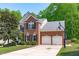 Charming two-story brick home with a two-car garage, well-manicured lawn, and a basketball hoop at 2412 Castleburg Dr, Apex, NC 27523