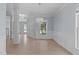 Open foyer with hardwood floors, decorative columns, a chandelier, and multiple entryways at 2412 Castleburg Dr, Apex, NC 27523