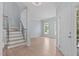 Bright foyer with hardwood floors, staircase, and view to the living area at 2412 Castleburg Dr, Apex, NC 27523