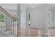 Bright and spacious foyer with hardwood floors, elegant chandelier, and staircase with wood railings at 2412 Castleburg Dr, Apex, NC 27523
