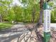 The Charleston Village Greenway trailhead and sign along a paved path at 2412 Castleburg Dr, Apex, NC 27523