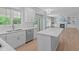 Modern kitchen with stainless steel appliances and quartz countertops overlooking living room at 2412 Castleburg Dr, Apex, NC 27523