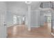 Open-concept living room with hardwood floors, decorative columns, and abundant natural light at 2412 Castleburg Dr, Apex, NC 27523