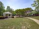 A gazebo sits on the edge of a manicured lawn with a playground in the background at 2412 Castleburg Dr, Apex, NC 27523