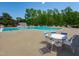 A community pool with a white tables and chairs and blue trim at 2412 Castleburg Dr, Apex, NC 27523