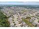 Expansive aerial view of a neighborhood featuring well-maintained homes and green spaces under a partly cloudy sky at 2912 Historic Cir, Morrisville, NC 27560