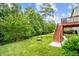 Scenic backyard with mature trees, grassy lawn, and charming swing set at 2912 Historic Cir, Morrisville, NC 27560