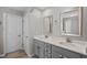 Stylish bathroom features double vanity, quartz countertop, framed mirrors and modern fixtures at 2912 Historic Cir, Morrisville, NC 27560
