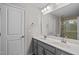 Bright bathroom featuring double sinks, spacious mirror, and walk in shower at 2912 Historic Cir, Morrisville, NC 27560
