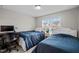 Inviting bedroom with twin beds, a desk, and window views of the neighborhood at 2912 Historic Cir, Morrisville, NC 27560