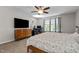 Bedroom with a window, ceiling fan, large TV, and dresser at 2912 Historic Cir, Morrisville, NC 27560