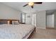 Bedroom features a ceiling fan, closet, and doorway to an adjacent bathroom at 2912 Historic Cir, Morrisville, NC 27560