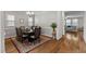 Well-lit dining area with hardwood floors, an elegant rug, and comfortable seating at 2912 Historic Cir, Morrisville, NC 27560