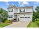 Charming two-story home featuring a two-car garage, manicured landscaping, and a welcoming front porch at 2912 Historic Cir, Morrisville, NC 27560
