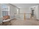 Second floor hallway with neutral colors, carpet and natural light at 2912 Historic Cir, Morrisville, NC 27560