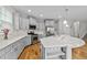 Bright kitchen features light gray cabinets, quartz countertops, stainless appliances, and hardwood floors at 2912 Historic Cir, Morrisville, NC 27560