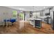 Open kitchen with modern appliances, island, and dining area with sliding glass door at 2912 Historic Cir, Morrisville, NC 27560