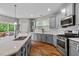 Open kitchen with stainless appliances, quartz countertops and hardwood floors at 2912 Historic Cir, Morrisville, NC 27560