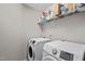 Efficient laundry room with modern washer and dryer units plus overhead storage at 2912 Historic Cir, Morrisville, NC 27560