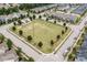 Aerial shot of a community green space with young trees, a gazebo, and neatly arranged homes in the background at 2912 Historic Cir, Morrisville, NC 27560