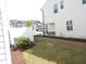 Backyard with a well-maintained lawn, mulch beds, and a white privacy fence at 3005 Dunnock Dr, Durham, NC 27713