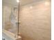 Modern bathroom featuring large beige tile walls and a glass-enclosed shower at 3005 Dunnock Dr, Durham, NC 27713