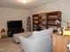 Relaxing den featuring a plush gray ottoman and a well-stocked custom bookshelf at 3005 Dunnock Dr, Durham, NC 27713