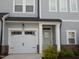 Charming townhome with a one-car garage, light blue door, and stone accents at 3005 Dunnock Dr, Durham, NC 27713
