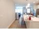 Open kitchen overlooking the living area with an island, bar stool seating, and stainless appliances at 3005 Dunnock Dr, Durham, NC 27713