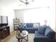 Comfortable living room with plush blue sectional and a ceiling fan at 3005 Dunnock Dr, Durham, NC 27713