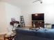 Spacious living room featuring a comfortable blue sofa and entertainment setup at 3005 Dunnock Dr, Durham, NC 27713