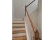 Elegant staircase with wooden treads and white risers, offering a clean design at 3005 Dunnock Dr, Durham, NC 27713
