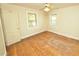 This bedroom has hardwood floors, natural light, and a ceiling fan at 315 Clark St, Durham, NC 27701