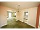 Dining room featuring natural lighting, a chandelier, and access to the living room and kitchen at 315 Clark St, Durham, NC 27701