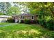 Cozy brick home with lush landscaping and a neatly maintained lawn at 315 Clark St, Durham, NC 27701
