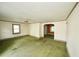 Bright living room featuring a ceiling fan, multiple windows, and a view to other rooms at 315 Clark St, Durham, NC 27701