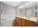 Well-lit bathroom with a double sink vanity, bathtub and shower combo, and neutral decor at 324 Providence Glen Dr, Chapel Hill, NC 27514