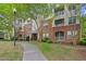 Apartment building with brick facade, balconies, and lush landscaping at 324 Providence Glen Dr, Chapel Hill, NC 27514