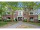 Beautiful brick condo building featuring well-manicured landscaping and tree lined walkways at 324 Providence Glen Dr, Chapel Hill, NC 27514