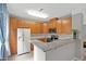 Well-lit kitchen featuring granite countertops, stainless steel appliances, and wood cabinets at 324 Providence Glen Dr, Chapel Hill, NC 27514